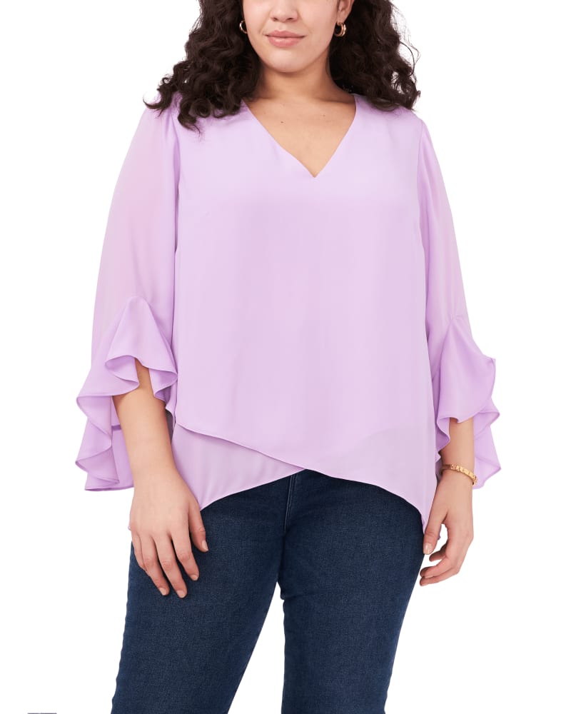 Front of a model wearing a size 1X Natalie Flutter Sleeve Tunic in SOFT IRIS by Vince Camuto. | dia_product_style_image_id:261424